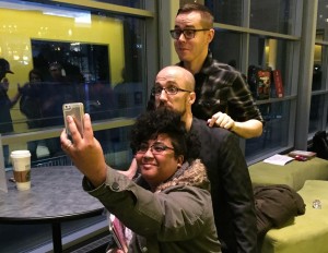 A fan cosplaying as Laura posing for a selfie with the creators of WicDiv
